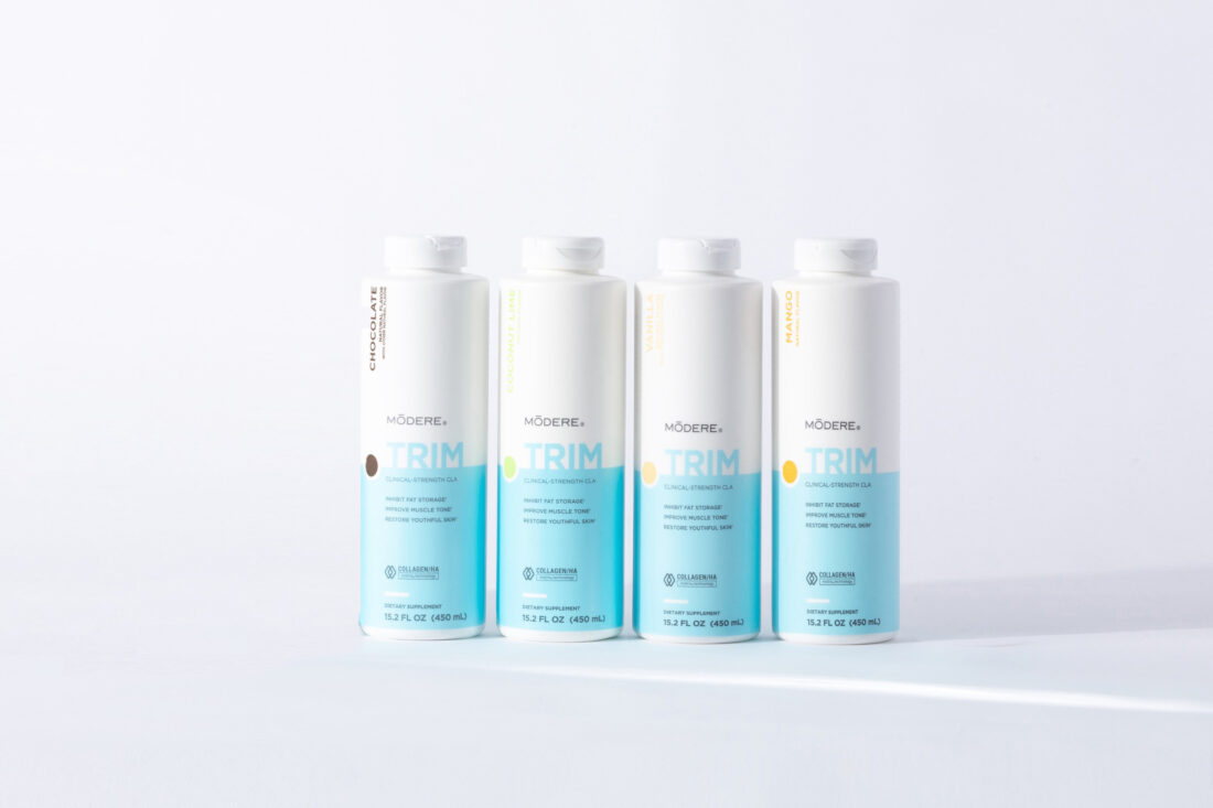 Several bottles of Modere Trim containing CLA and Collagen/HA Matrix® Technology shown in different flavors.
