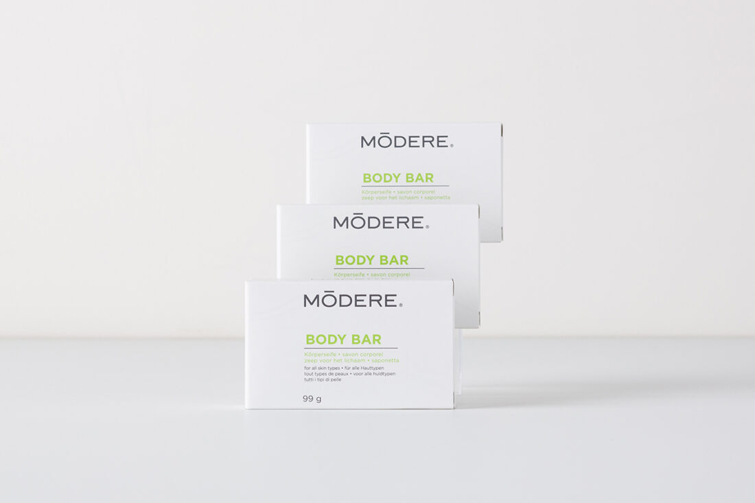 Product shot of 3 Modere Body Bars, stacked behind one another